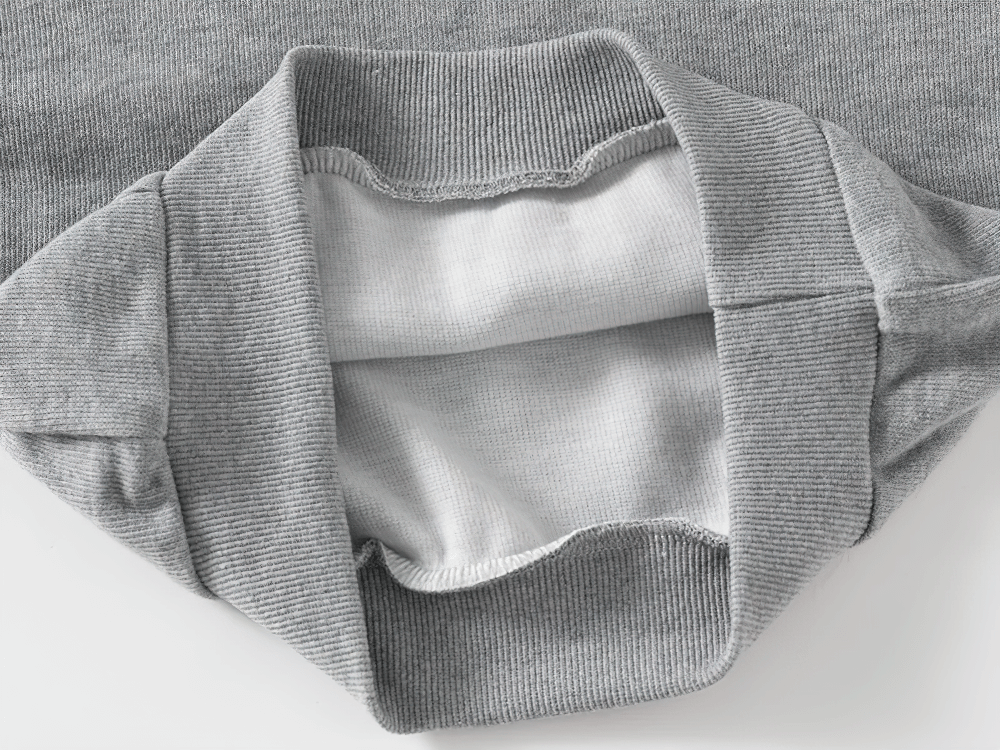 Close-up of a gray kid's hooded sweatshirt with fleece lining, showing soft interior and stylish design with white stripes on the sleeves.